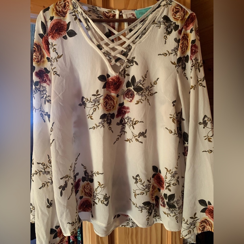 White floral blouse with flowy sleeves.